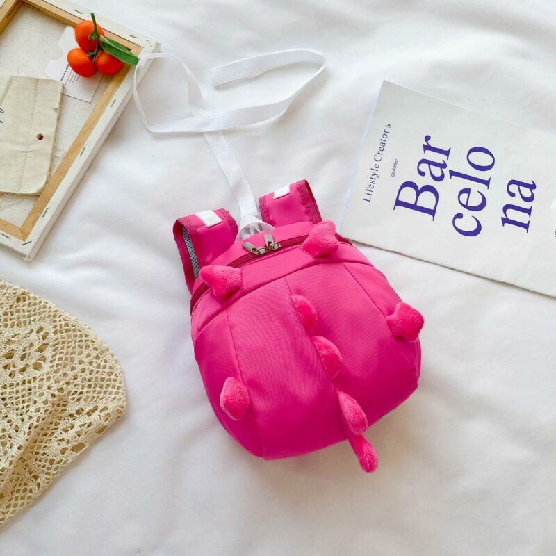Zaino scuola dell'infanzia dinosauro rosa con letto bianco
